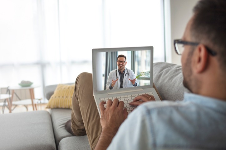 Man-using-laptop-and-having-video-call-with-his-doctor-1249721162_726x484-1