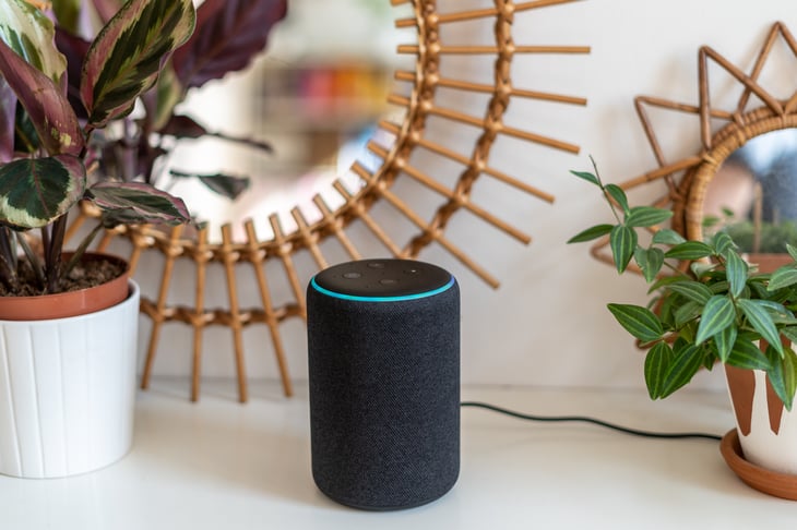 Amazon-Alexa-Echo-Plus-on-a-white-table-with-green-plants-in-the-background-1142153206_1257x838