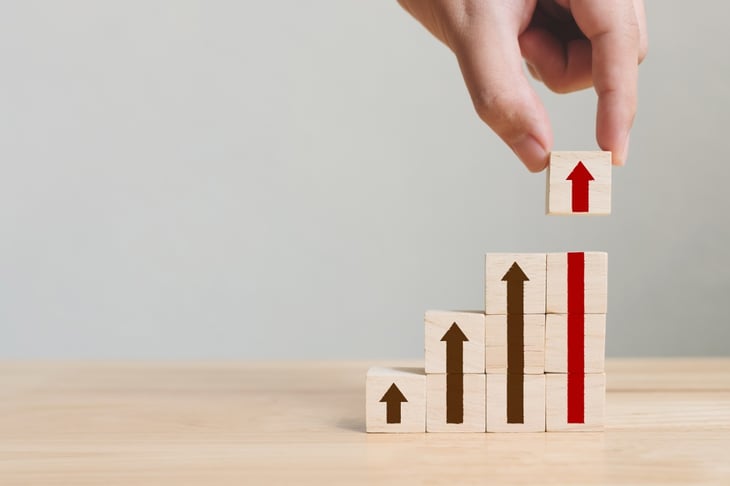Hand-arranging-wood-block-stacking-as-step-stair-with-arrow-up.-Ladder-career-path-concept-for-business-growth-success-process-1017183520_2125x1416-1
