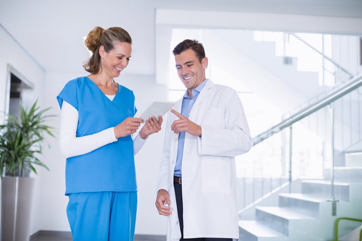 Nurse-and-doctor-discussing-over-digital-tablet-653812364_1258x838
