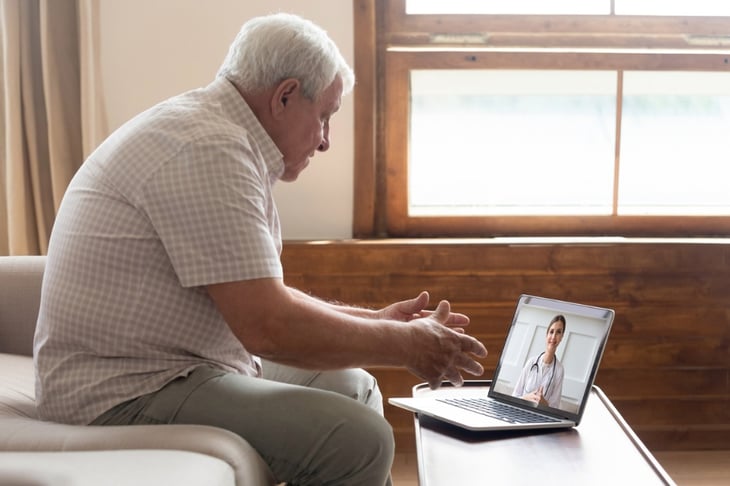 elderly-man-make-distant-video-call-communicating-with-doctor-online-picture-id1182248151