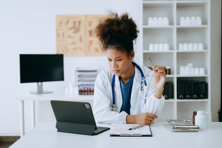 female-african-adult-doctor-consultation-room-having-a-videoconsultation-on-tablet-web