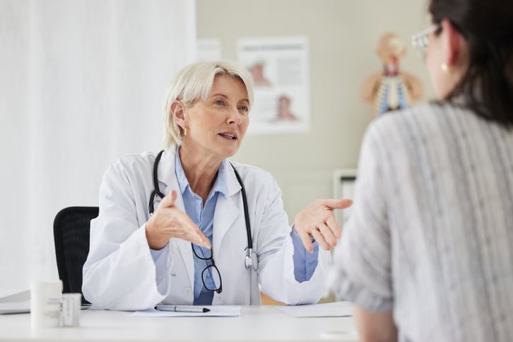 female-european-adult-doctor-consultation-room-talking-with-her-patient-web-1