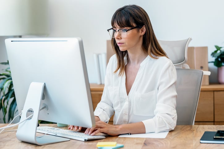 female-european-adult-doctor-consultation-room-typing-on-her-computer-web