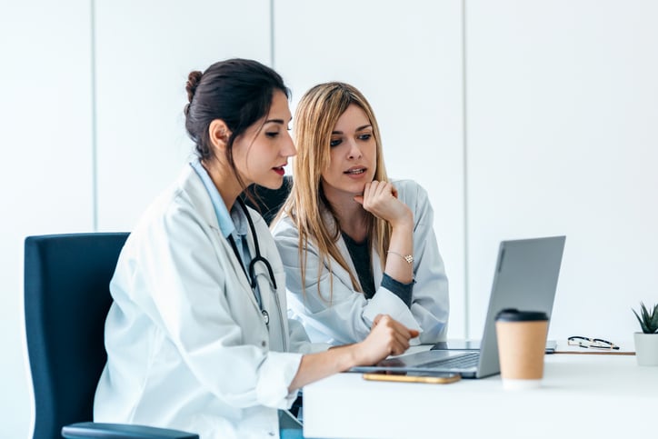 female-european-adult-doctor-front-of-computer-web