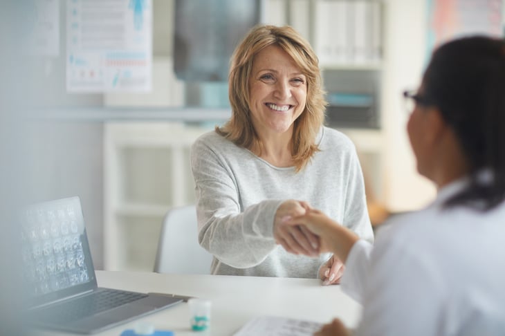 female-european-elderly-patients-consultation-room-shaking-hands-with-doctor-print
