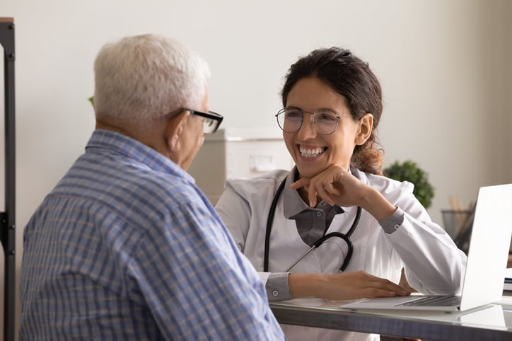 female-latin-american-adult-doctor-consultation-room-smilling-and-listening-to-her-senior-patient-print