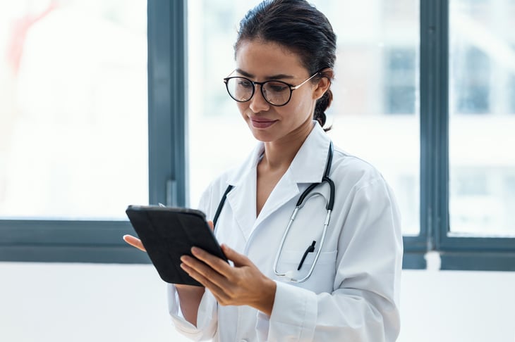 female-latin-american-adult-doctor-using-her-tablet-web