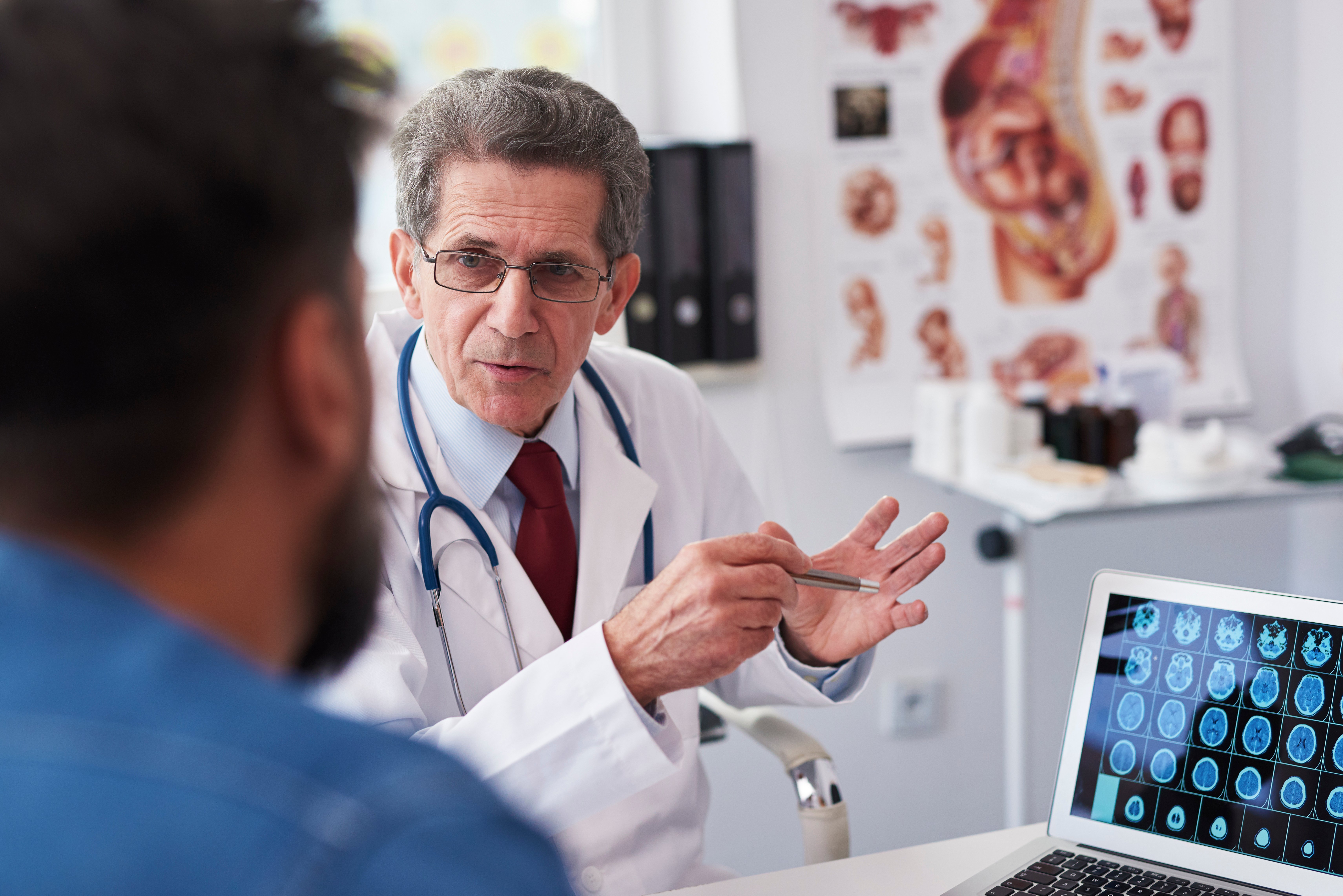 male-european-elderly-doctor-consultation-room-talking-with-male-patient-print