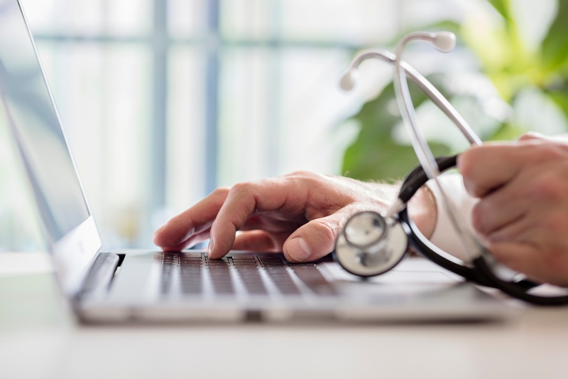 Doctor-entering-patient-notes-on-laptop-in-surgery-924365076_8549x5699 (1)-1